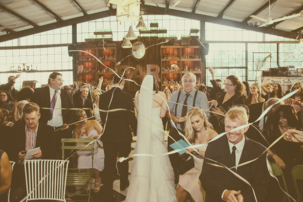 Bridea and Groom get covered in streamer confetti at Katys Palace Bar Wedding Venue