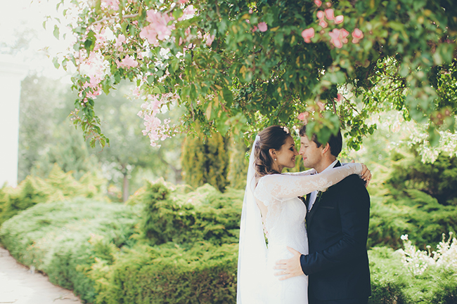 wedding couple embracing each other under a tree