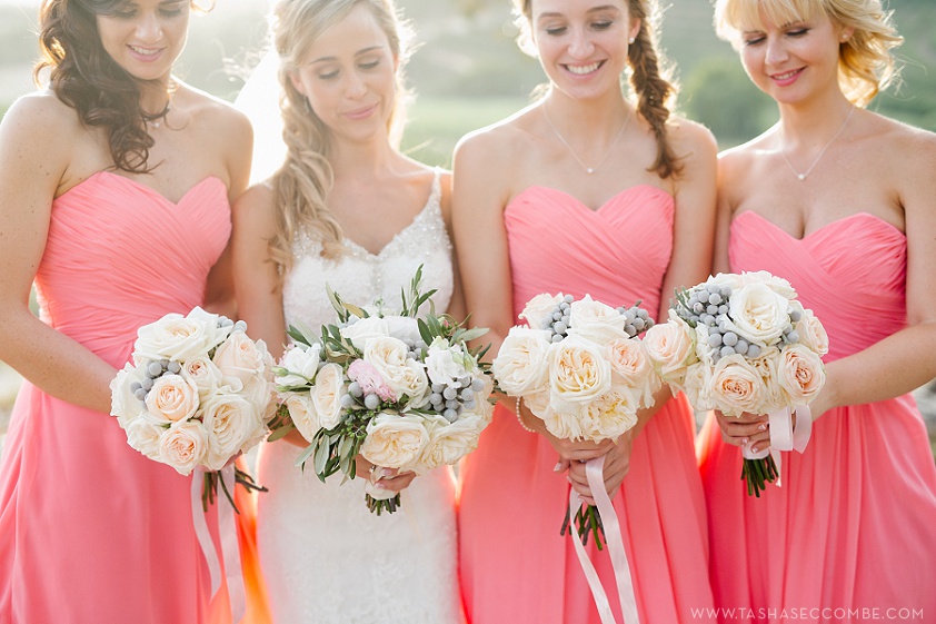 Bride with her bridesmaids in pink dresses with bouquets