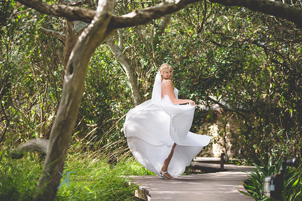 Bride dancing on the Walkway among the trees at Mosaic Wedding Venue