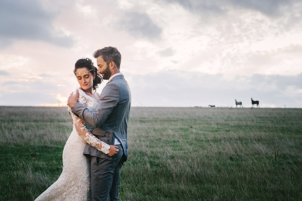 Wedding Couple Embrace in a Field at Cape Town Wedding Venue 