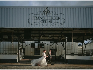Franschhoek Cellar Wedding Venue Couple Walk past the Warehouse