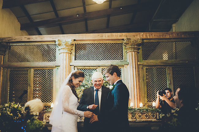 Bride and groom with minister in wedding chapel