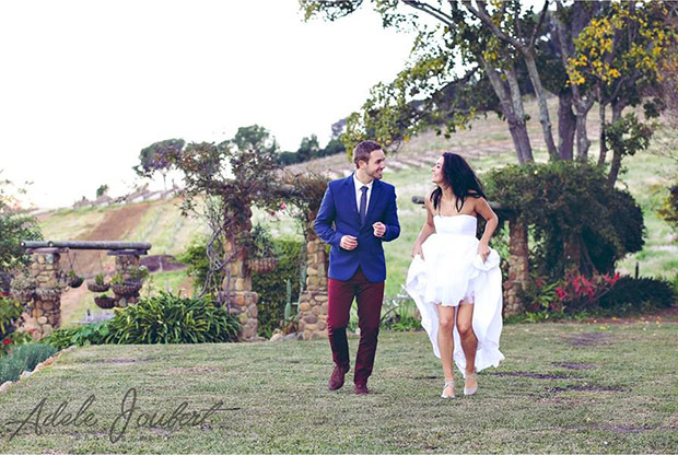 Bride and Grrom Frolic on the Lawn at The Venue At Pearl Mountain Wedding Venue Paarl